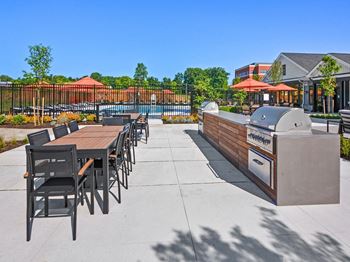 the reserve at city center clubhouse patio with grill and dining table